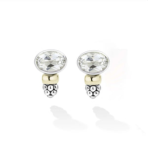 A pair of silver and yellow gold stud earrings with oval-cut white gemstones, shown on a clean white background with soft reflections.