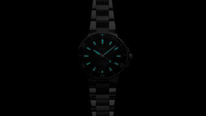Black wristwatch with blue glowing hands on a black background