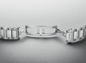 Silver watch strap on a gray background