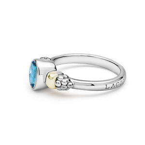 side view of a two tone ring with a blue center stone
