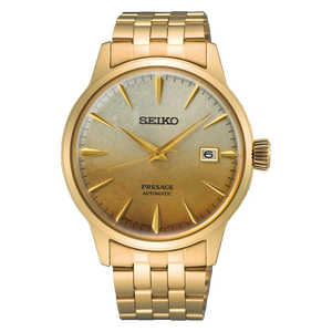 A Seiko Presage Automatic watch with a gold-tone stainless steel case and integrated bracelet, featuring a champagne-gold gradient dial with gold-tone indices and a date window at the 3 o'clock position.