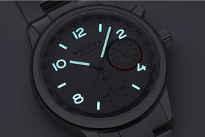 Glowing watch face on a dark background