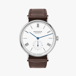 NOMOS timepiece with white dial blue hands and brown leather band