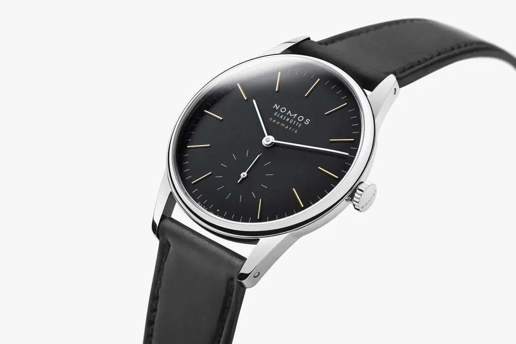 Black wristwatch with silver case on a white background
