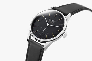 Black wristwatch with silver case on a white background