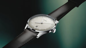 Wristwatch with a black strap and silver case on a gradient background