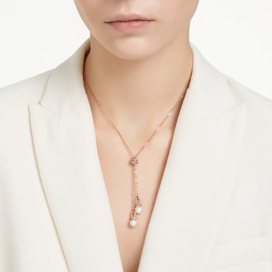 Close up front view of Originally Y pendant in rose gold tone with two dangling pearls and pave accents