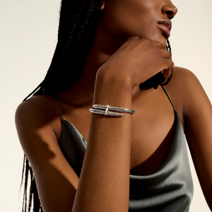Close up of wrist wearing Sterling Silver Spear Flex Cuff showing spear shaped ends and textured band on neutral background
