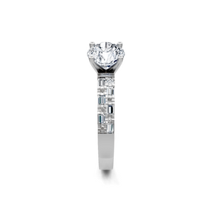 Round brilliant solitaire diamond engagement ring, baguette-accented white gold band, straight-on view.