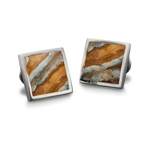 Front view of William Henry Brown Mammoth cufflinks with square sterling settings and brown fossil inlay on white