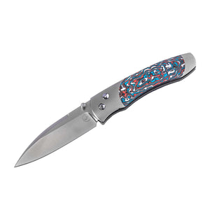 Angled view of William Henry A300-11 knife with open S35VN blade and Flame Ocean multicolored carbon fiber inlay on white