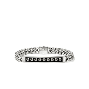 A silver-toned metal bracelet featuring a curb chain design, a central polished bar, and a row of small dome-cut stones on a black inlay, shown against a plain white background.