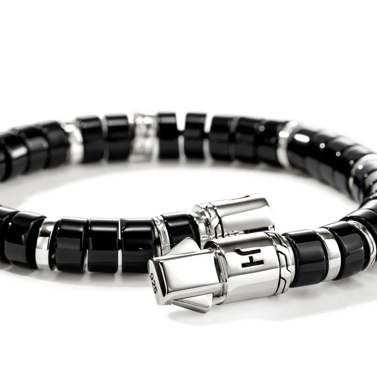 Black beaded bracelet with silver clasp on a white background