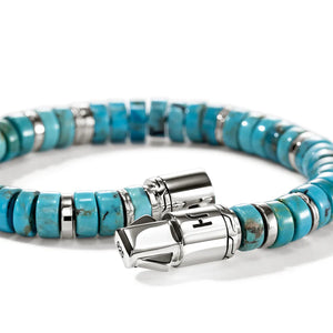 Turquoise beaded bracelet with silver clasp on a white background