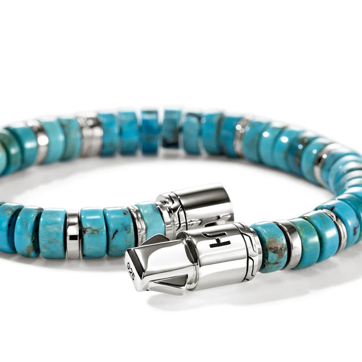 Turquoise beaded bracelet with silver clasp on a white background