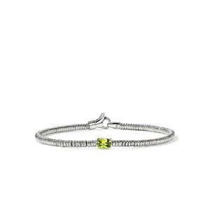 silver beaded bracelet with a light green center stone on a white background