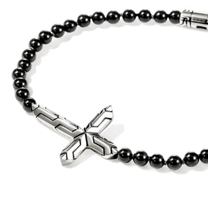 Black beaded bracelet with a silver cross pendant on a white background