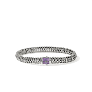 Silver bracelet with amethyst gemstones on a white background