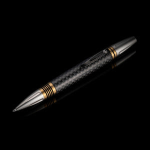 Diagonal view of William Henry Caribe 15 pen showcasing carbon fiber barrel and brass spacers on black reflective background