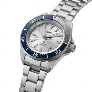 Seiko watch with silver bracelet and blue bezel on a white background
