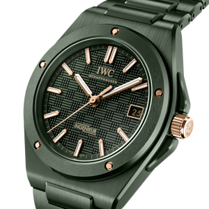 Green ceramic IWC watch with rose gold accents on a white background