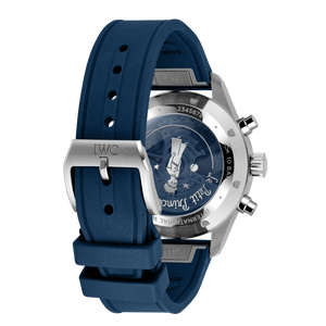 Angled rear view of Pilot's Watch Chronograph Le Petit Prince showcasing blue rubber strap and silver engraved case back on white background