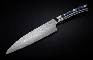 Angled view of Kultro Pro chef knife showcasing Damascus-patterned blade and maple handle on dark gradient background