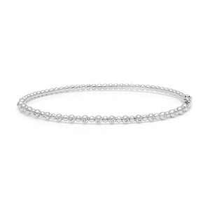 Top-down view of 14K white gold beaded diamond bangle showing round bead detail and small bezel-set diamonds on white background