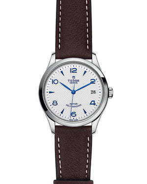 Front view of Tudor 1926 36mm steel watch with opaline dial, blue hands and numerals, brown leather strap, date at 3 o'clock
