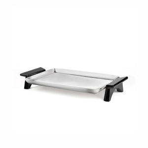 Three-quarter view of Circa rectangular tray showcasing brushed stainless steel surface and black angled handles on white background