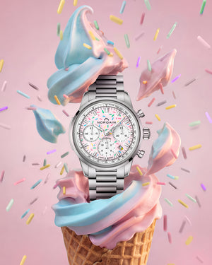 Silver watch on a colorful ice cream cone with sprinkles on a pink background
