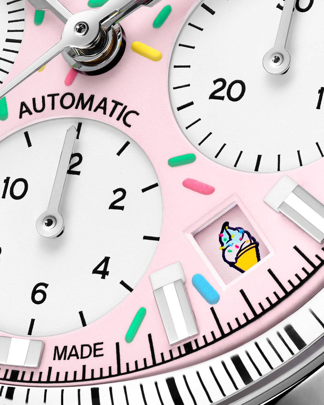 Close-up of a pink watch face with colorful accents and ice cream icon.