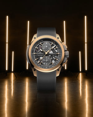 Luxury watch with a dark strap and detailed face on a reflective surface with vertical lights in the background