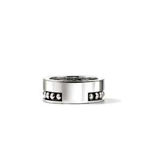 Silver ring with embedded stones on a white background