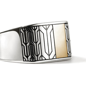 Silver and gold ring with geometric design on a white background