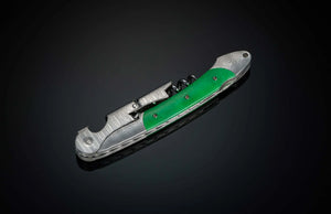 Angled view of William Henry Canopy wine opener and corkscrew with patterned steel and green handle on black background
