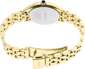 Back side of a gold tone seiko watch on a white background
