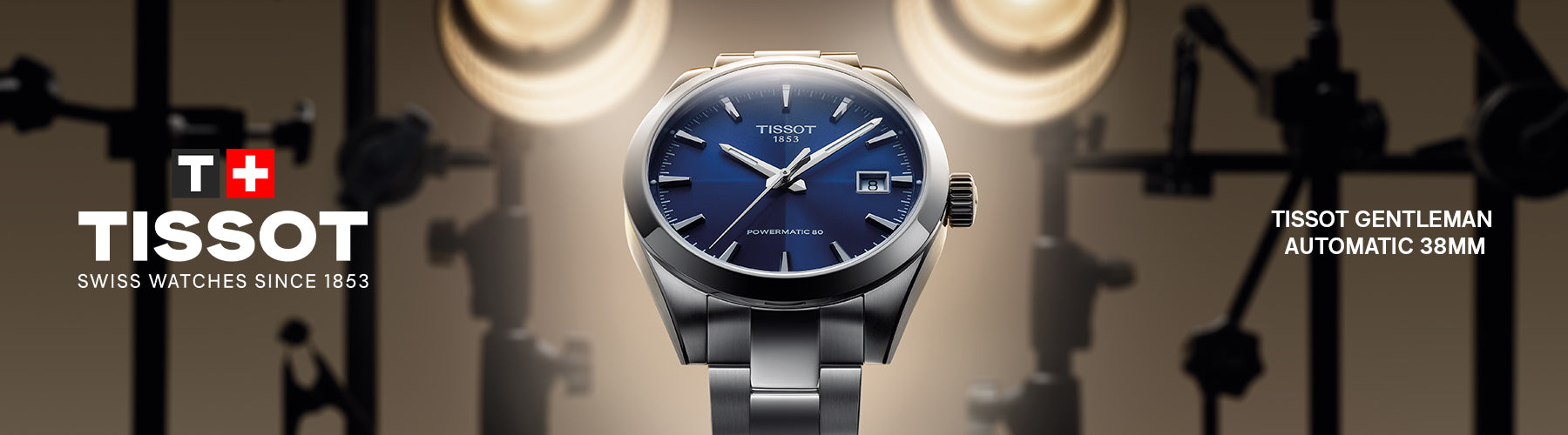 Tissot watch with blue dial and silver bracelet with Branded logo with movie lights in the background