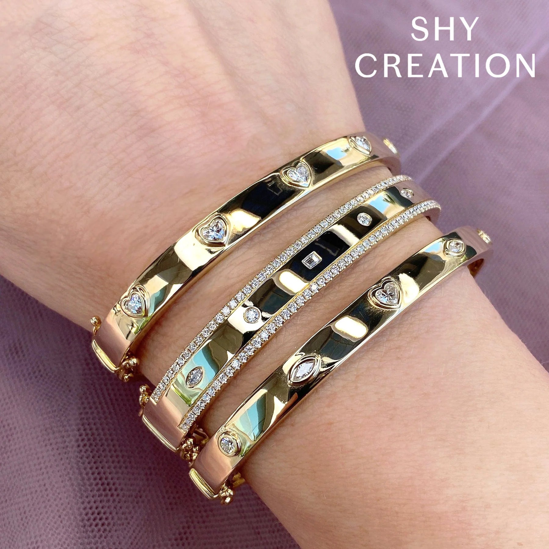 Close-up of 1.08ctw Mixed Shaped Diamond Bangle showing mixed-shaped diamonds in 14K yellow gold, SHY CREATION text