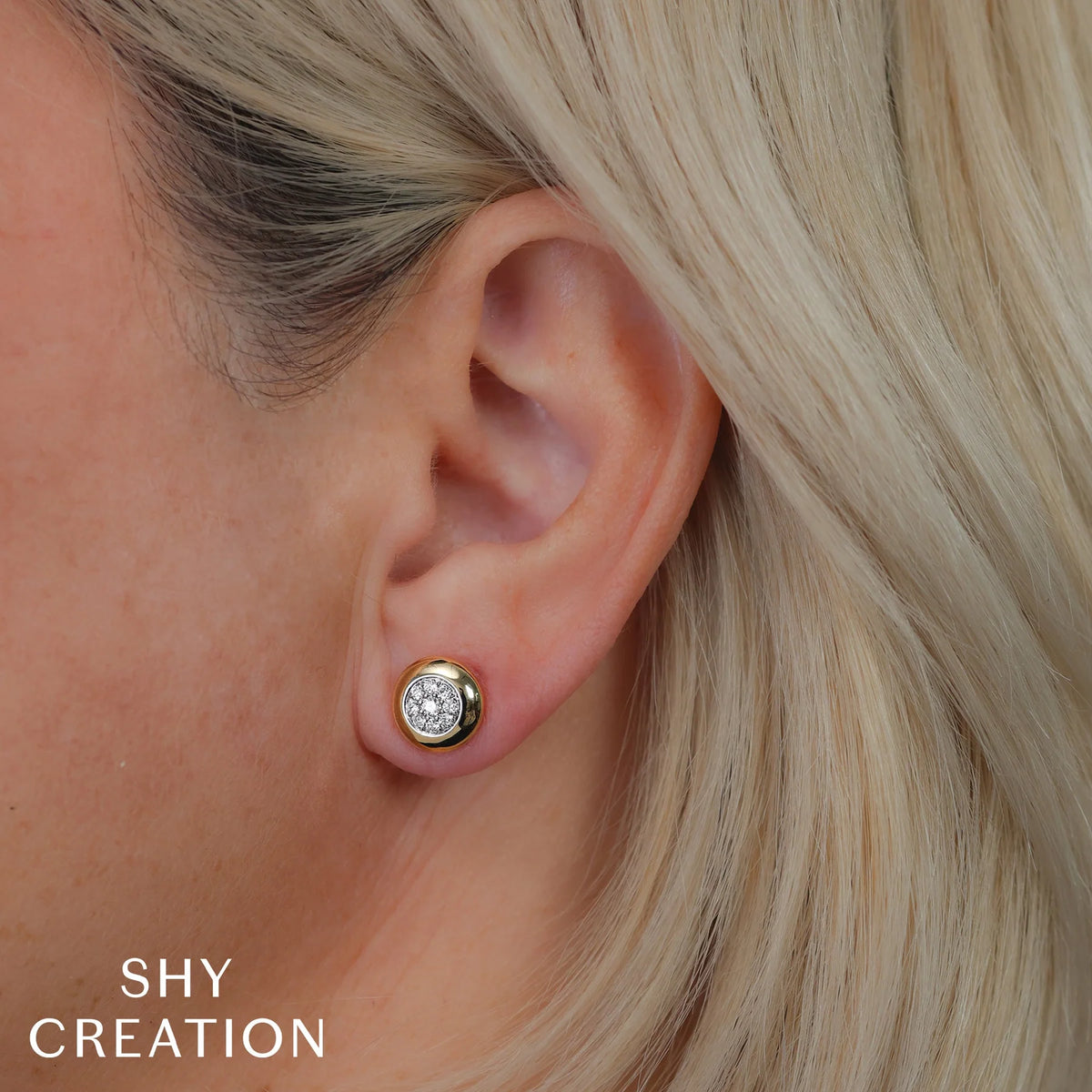 Close-up of 0.26ctw Diamond Circle stud earring on ear showcasing pave diamond cluster in 14K white gold bezel with blonde hair and SHY CREATION text