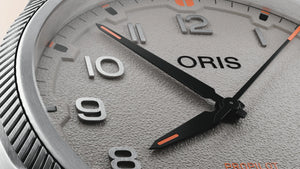 Close-up of an Oris watch face with detailed design.