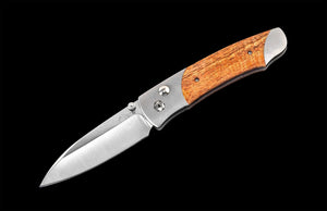 Folding knife with wooden handle on a black background