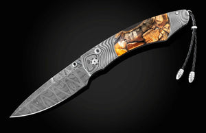 Forked blade knife with decorative handle on a black background