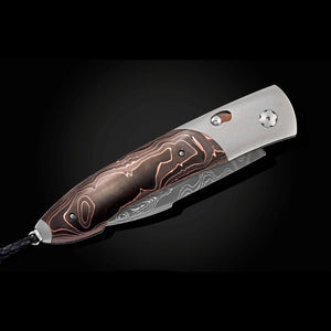 Folding knife with a decorative wooden handle on a black background