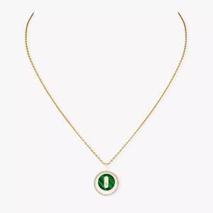 Gold necklace with a green pendant on a white background