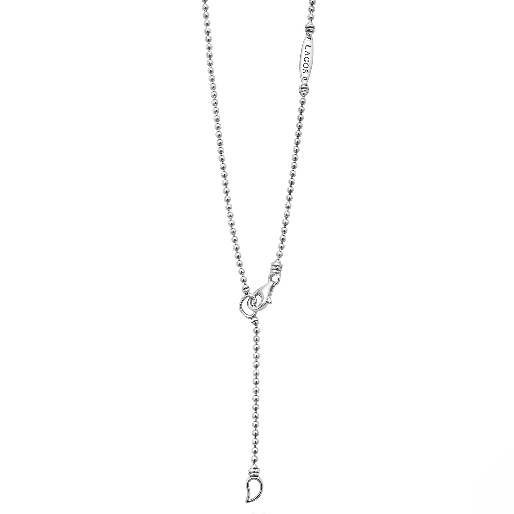 Close-up of linear diamond pendant necklace with caviar beaded sterling chain, lobster clasp and teardrop lariat drop