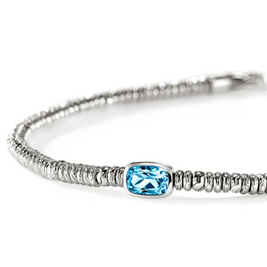 A silver-toned beaded bracelet featuring a central rectangular light blue gemstone, photographed on a clean white background.
