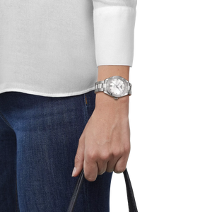 Person wearing a silver watch on a white background