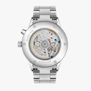 A stainless steel automatic watch with a transparent round case showing the intricate mechanical movement inside, paired with a matching steel link bracelet, photographed against a light gray background.