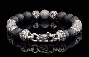 William Henry Monomyth bracelet — faceted black onyx beads and engraved silver beads with decorative clasp and reflection.